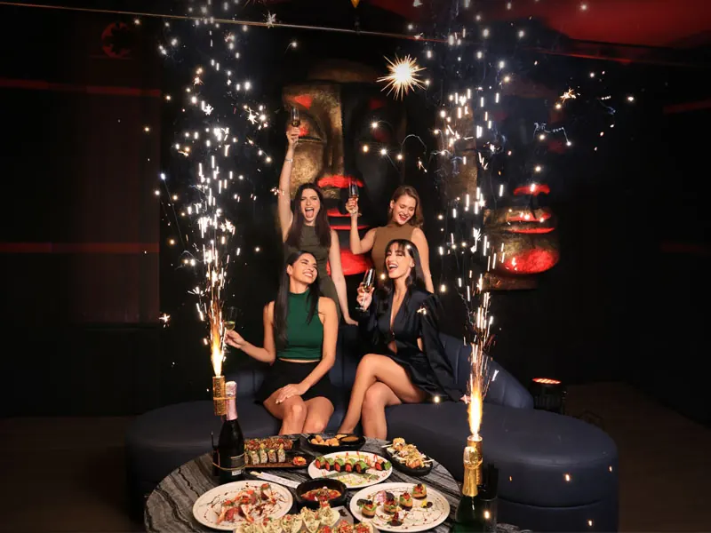 Vibrant nightclub lounge with atmospheric lighting and DJ booth